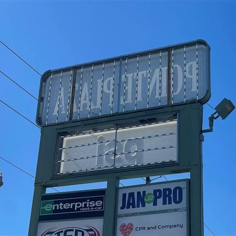 Pylon sign at Pointe Plaza undergoing LED retrofit with visible light strips and clear panel frames.