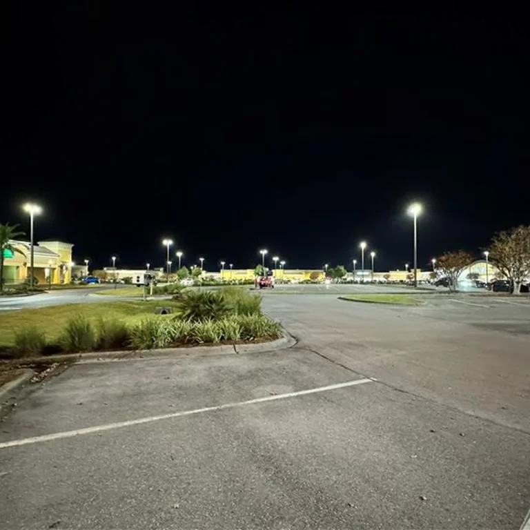 Commercial parking lot with energy-efficient LED pole lighting installed for nighttime visibility and safety.