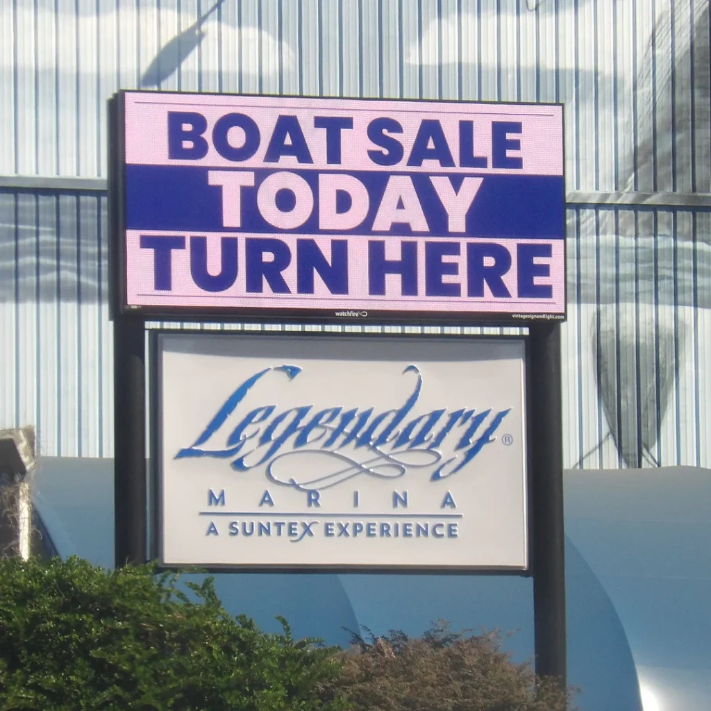 Watchfire LED sign displaying “Boat Sale Today Turn Here” above the Legendary Marina monument sign, installed by Vintage Sign & Light.