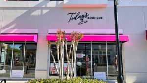 Today’s Boutique custom storefront lettering mounted above bright pink awnings and retail windows.