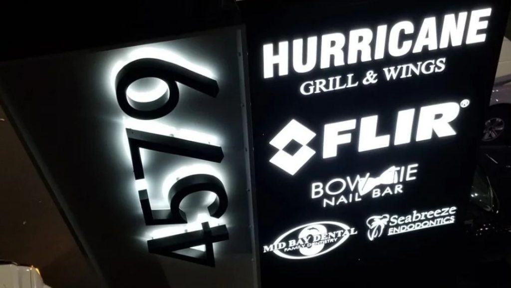LED monument sign Lutz FL showcasing businesses including Hurricane Grill & Wings, FLIR, Bowie Nail Bar, Mid Bay Dental, and Seabreeze Endodontics with address number 4579 illuminated.