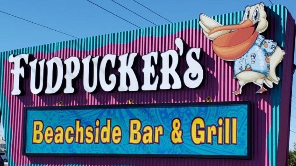 Themed monument sign for Fudpucker’s Beachside Bar & Grill featuring bold colors and custom character art, an example of creative work by monument sign companies in Florida.