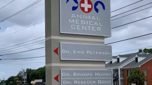 Multi tenant monument signs featuring Animal Medical Center with doctor names listed on panels.