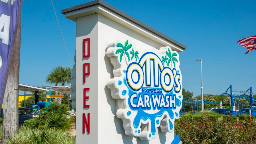 Custom monument sign by Vintage Sign & Light for Otto’s Express Carwash surrounded by landscaping