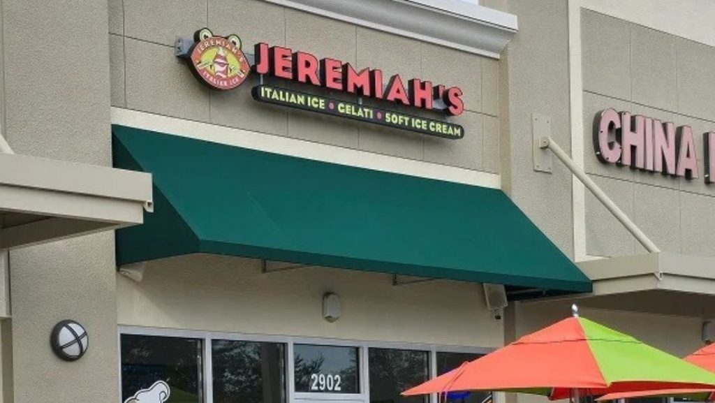 Green fabric restaurant awning Dade City FL above Jeremiah’s Italian Ice storefront, enhancing curb appeal and providing shade for customers.