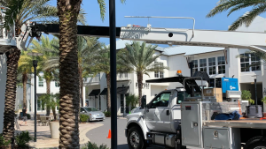 Vintage Sign & Light service truck and boom lift positioned at a commercial sign installation site.