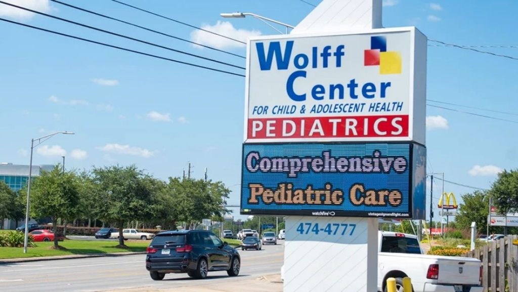 Roadside monument sign with LED display for Wolff Center Pediatrics, an example of commercial signage that may require a signage permit for installation.
