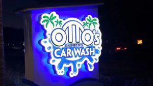 LED monument sign for Otto’s Express Car Wash at night showing bright illuminated logo, example of cost of LED monument sign