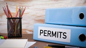 office desk with binder labeled permits and stationery