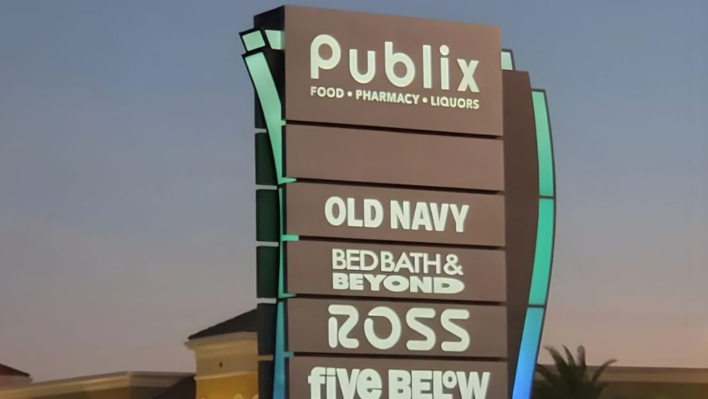 illuminated retail monument sign with multiple business names including Publix and Old Navy