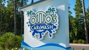 Modern monument signs with a custom dimensional Otto’s Express Car Wash logo on an outdoor roadside entrance display.