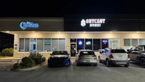 Illuminated channel letter signs installed on a multi-tenant commercial storefront.