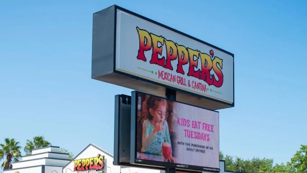 Restaurant monument sign with a Watchfire outdoor LED display promoting a weekly dining special.
