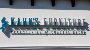 Channel letters mounted on a light stucco commercial storefront.